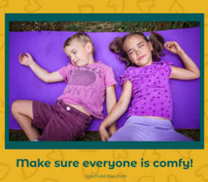 Two children sleeping on a purple yoga mat outdoors during a family camping trip with text overlay "make sure everyone is comfy!